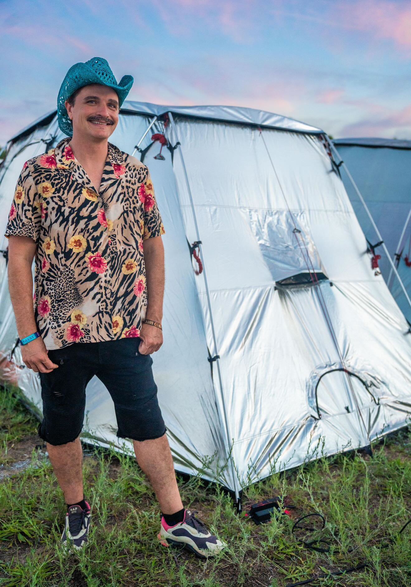 Tucker Gumber, The Festival Guy, in front of a FestPro tent at sunset